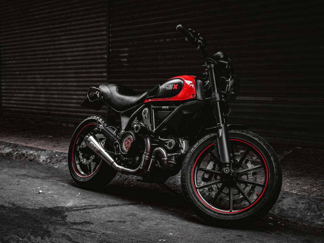 Black and Red Motorcycle Parked Beside the Roller Shutter